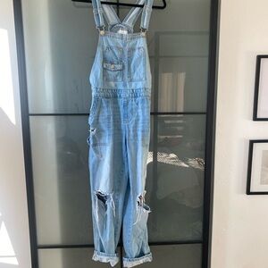 Celebrity pink distressed light denim overalls